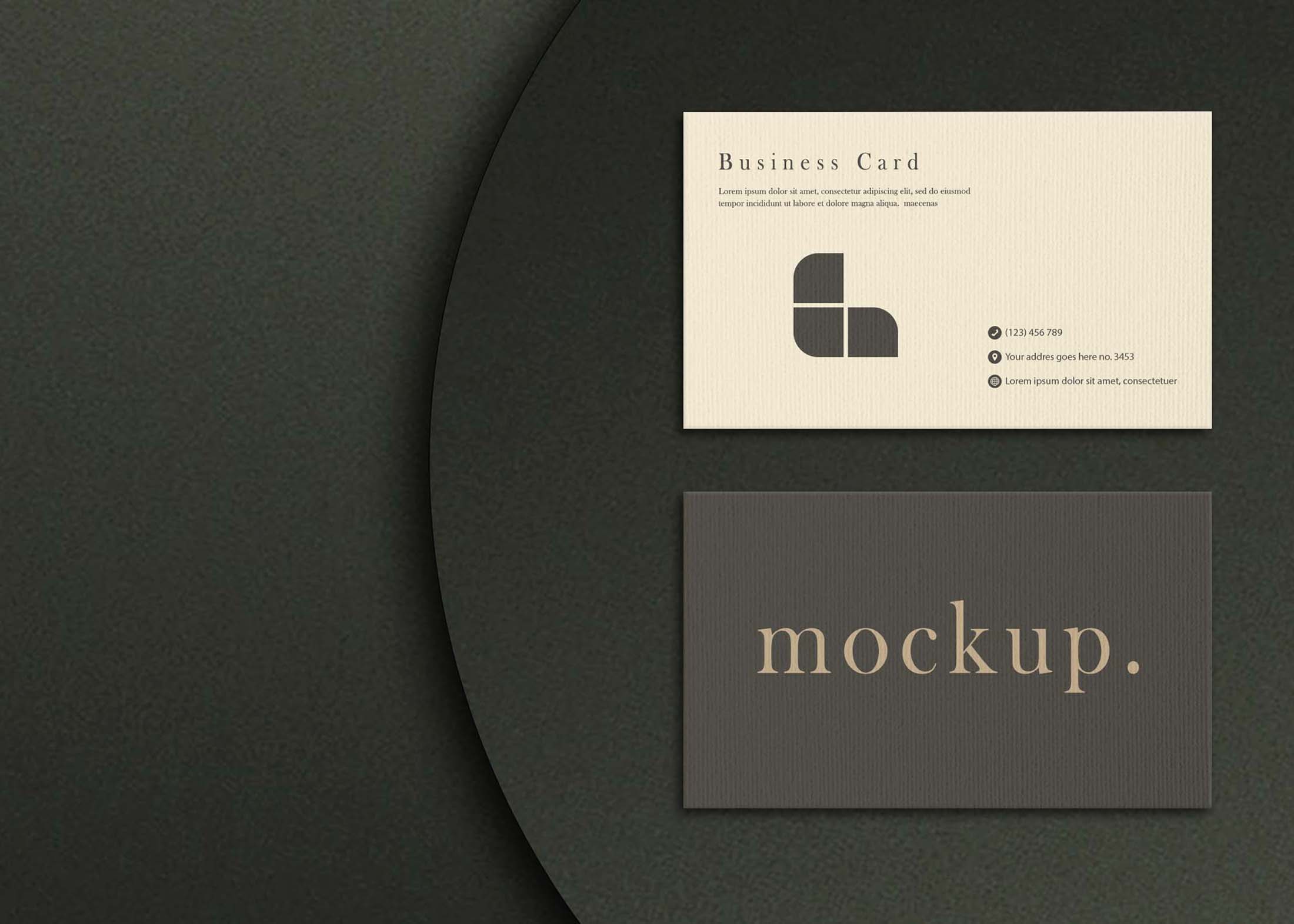 A light beige business card with a logo and contact details sits atop a dark circular background, alongside a dark card 