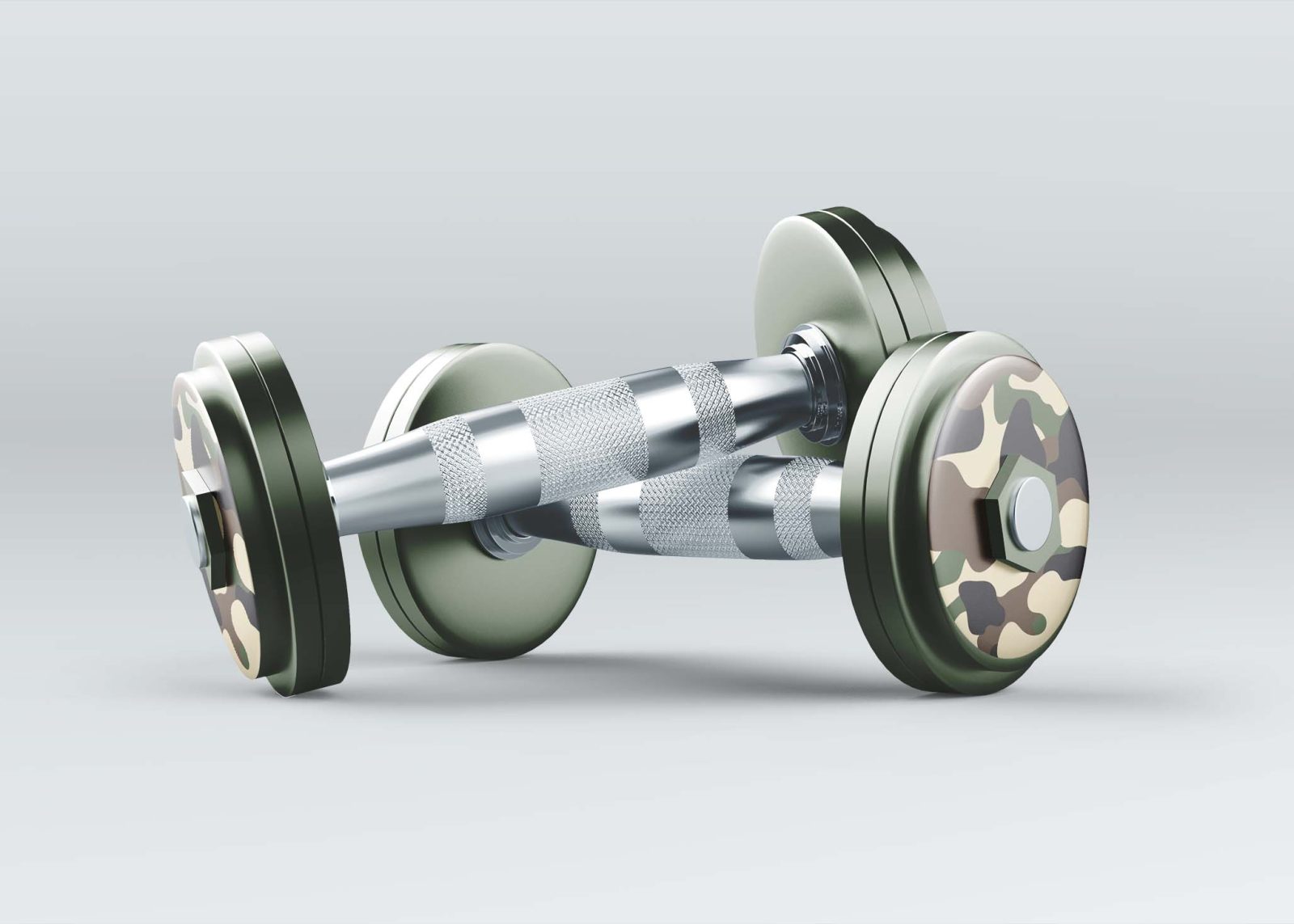 A camouflaged dumbbell with metallic grips rests on a light gray background.