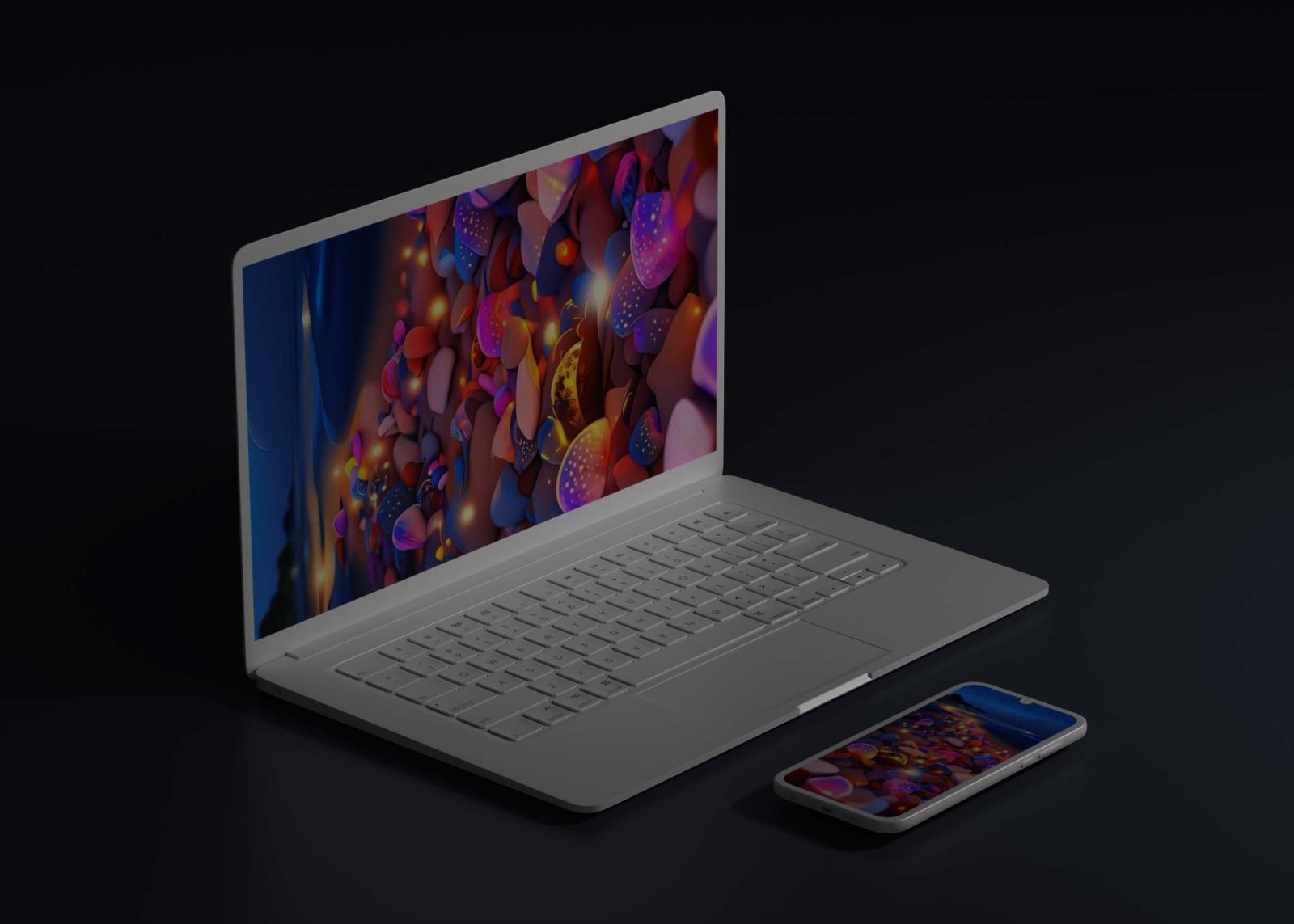 A silver laptop with a vibrant, colorful abstract wallpaper sits next to a smartphone displaying a similar design.
